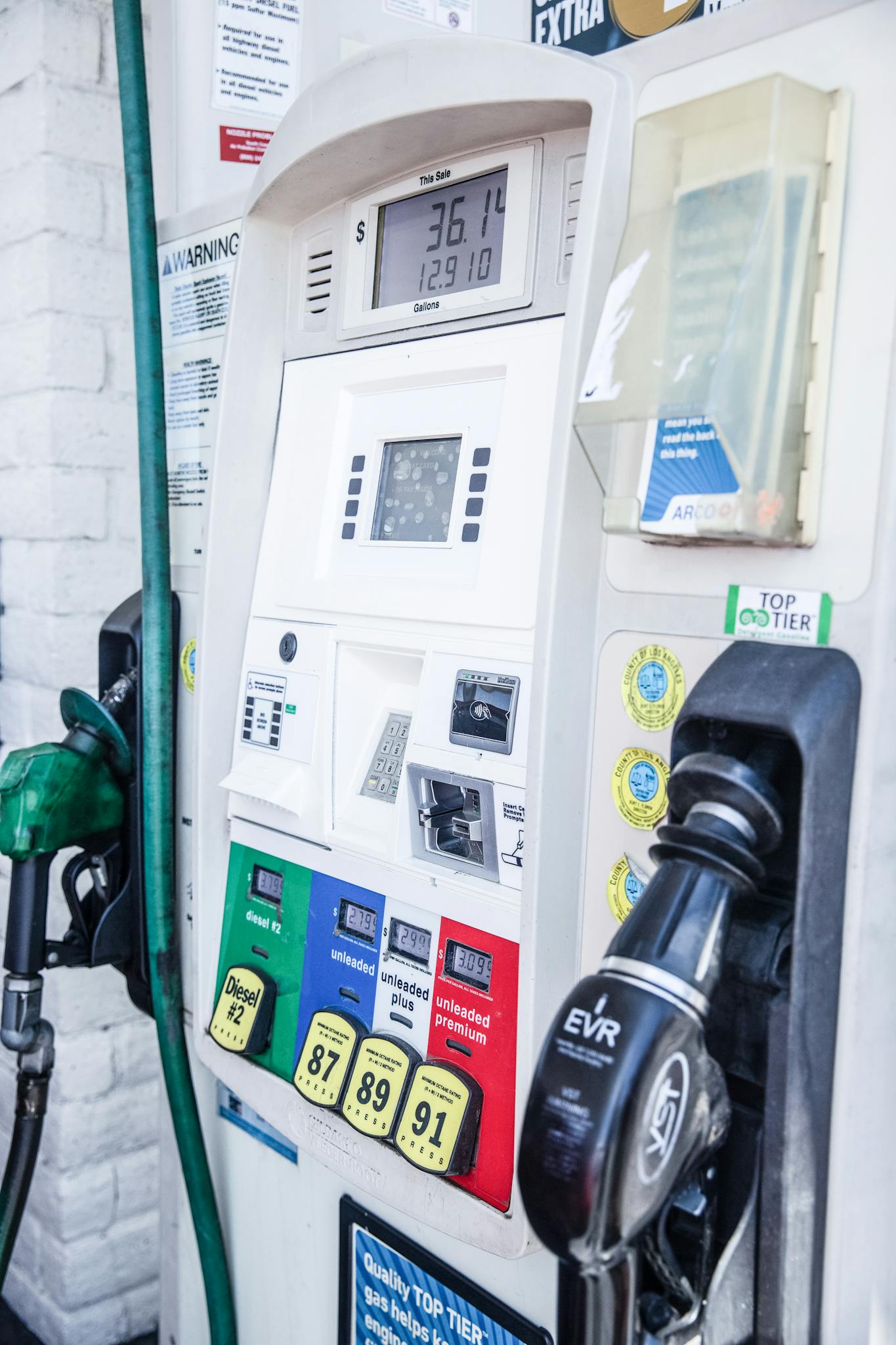 Close-up of a modern gas pump at a Los Angeles fuel station showing fuel options and digital display.